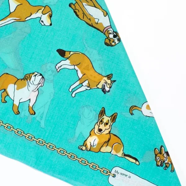 A close up photo of the dog bandannas showing cartoon dog and puppy print designs