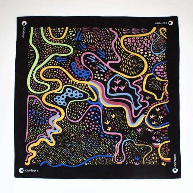 A wide shot photo of the Dreaming Track Nights bandana laid out flat