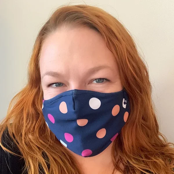 a person wearing a polka dot face mask