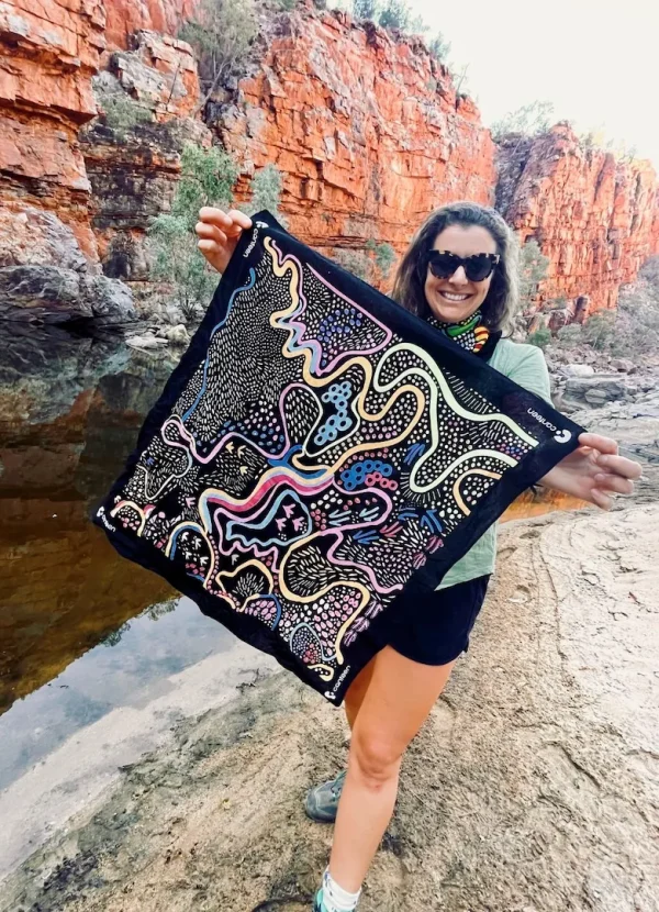 A person holding a Dreaming Track Nights bandanna