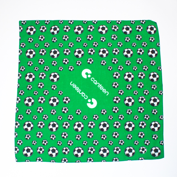 A wide shot photo of the green soccer bandana laid out flat